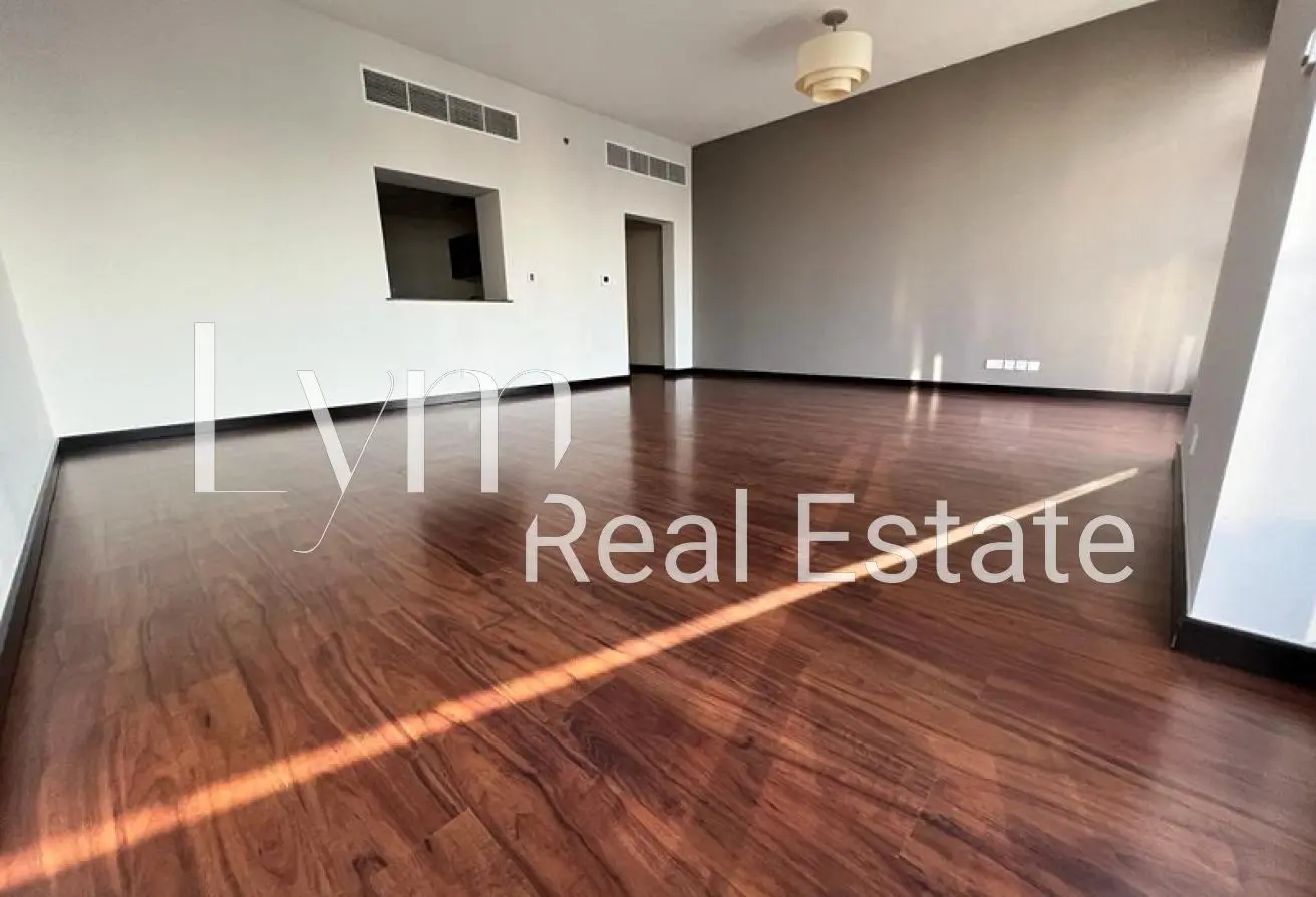 Green Lakes S2 living room with dark timber flooring and kitchen serving hatch, JLT